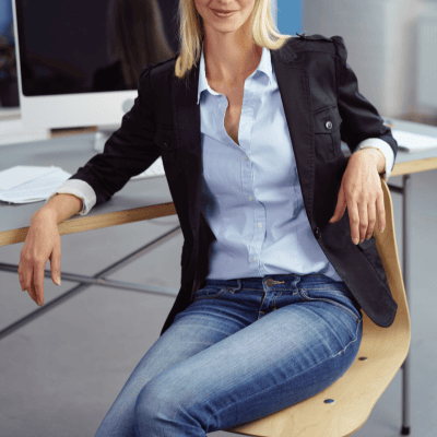 polished, stylish businesswoman wears a business casual blazer and jeans