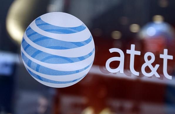 Citing regulatory uncertainty around the classification of broadband Internet, AT&T said Wednesday it will pause capital investments in 100 cities.