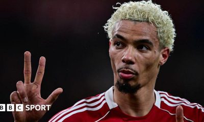 Hugo Ekitike gestures the score to Newcastle fans at Anfield