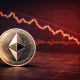 An Ethereum coin placed in front of a red downward cryptocurrency price chart showing a market decline.