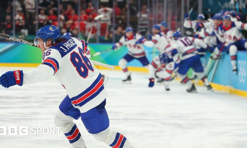 USA players celebrate winning the men's gold medal ice hockey match between Canada and USA