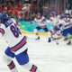 USA players celebrate winning the men's gold medal ice hockey match between Canada and USA