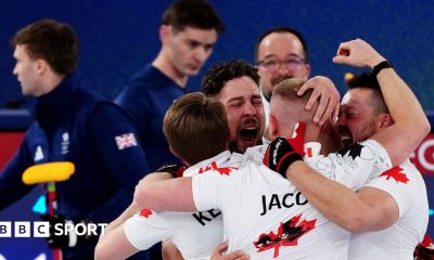 Canadian curlers celebrate after their defeat of Great Britain's team, two members of which are seen on the right