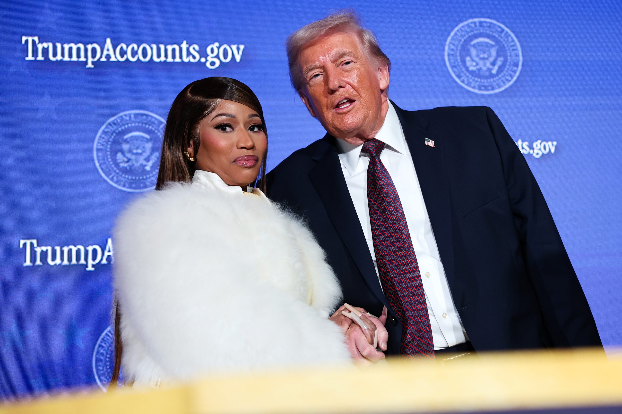 Musician Nicki Minaj joins President Donald Trump on stage as he delivers remarks during the Treasury Department's Trump Accounts Summit on Jan. 28, 2026 in Washington, D.C.