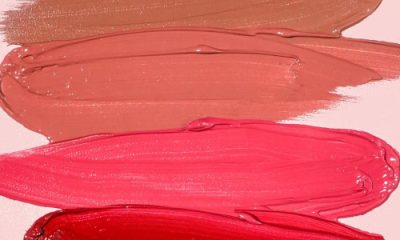 smears of colorful lipstick against a pink background