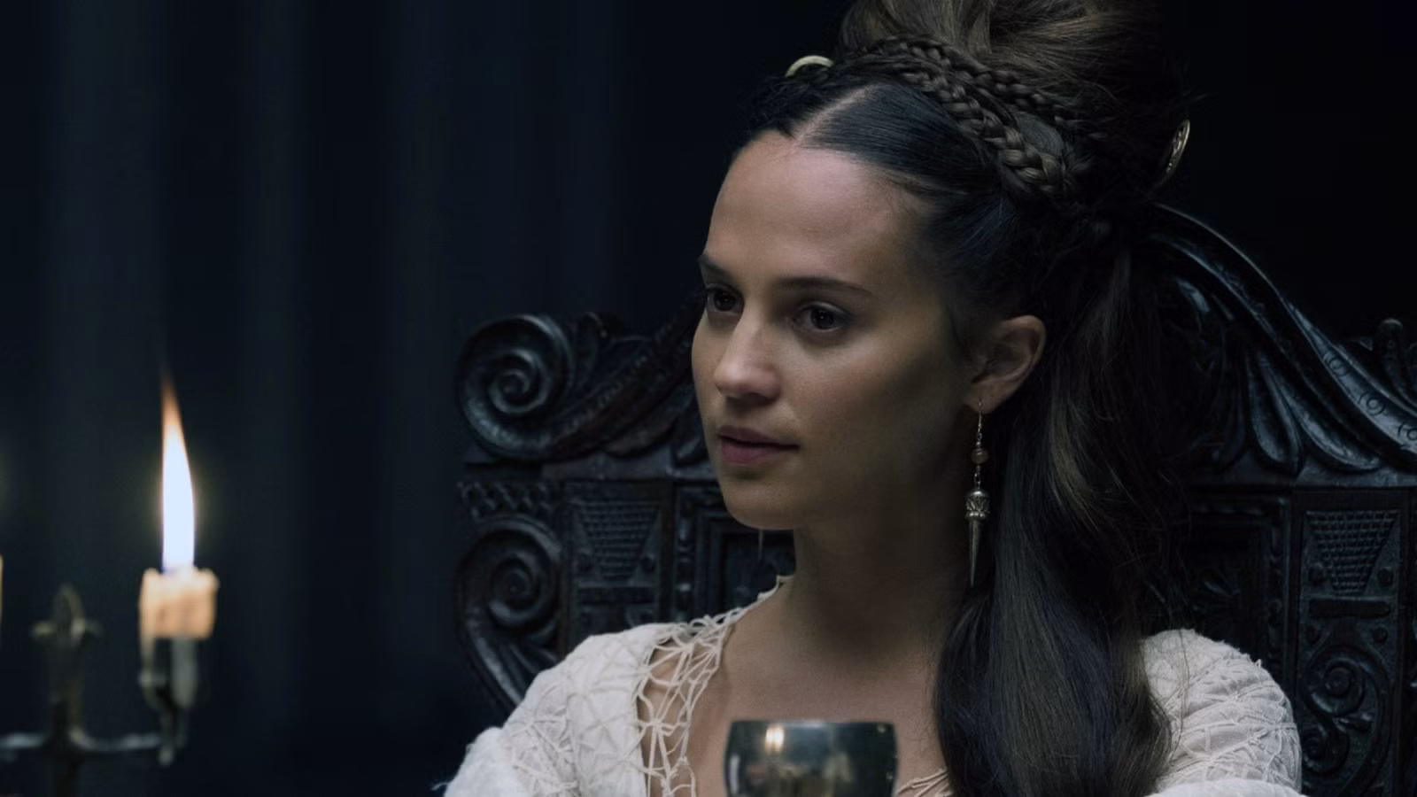 Alicia Vikander at a fancy dinner table in The Green Knight