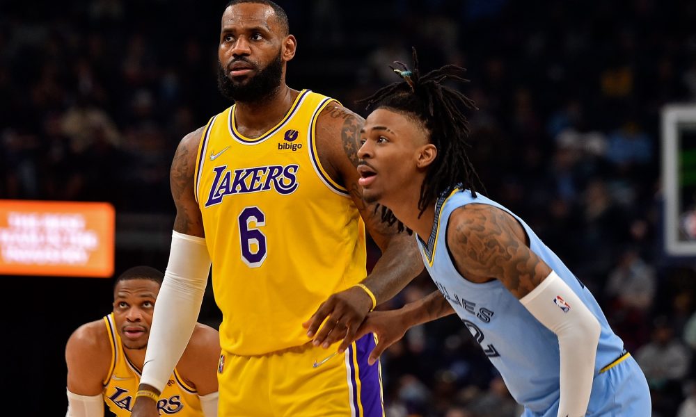 Memphis Grizzlies' Ja Morant guarding Los Angeles Lakers' LeBron James during a regular season game.