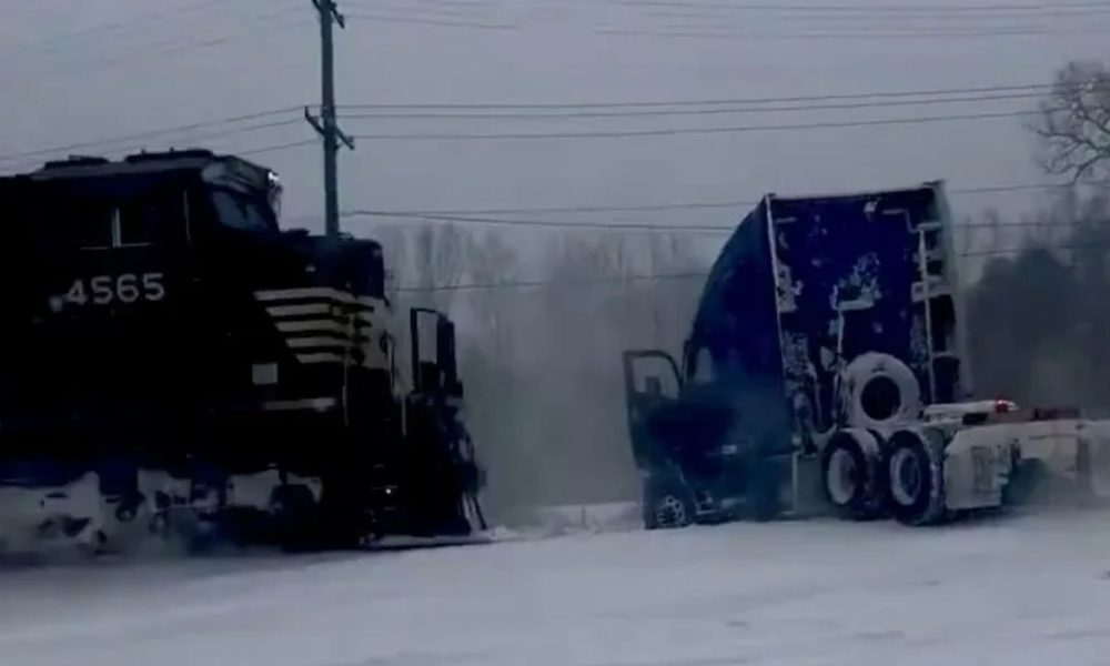Heart-stopping moment train smashes into a truck stuck on the rail line after a 'bomb cyclone' snowstorm