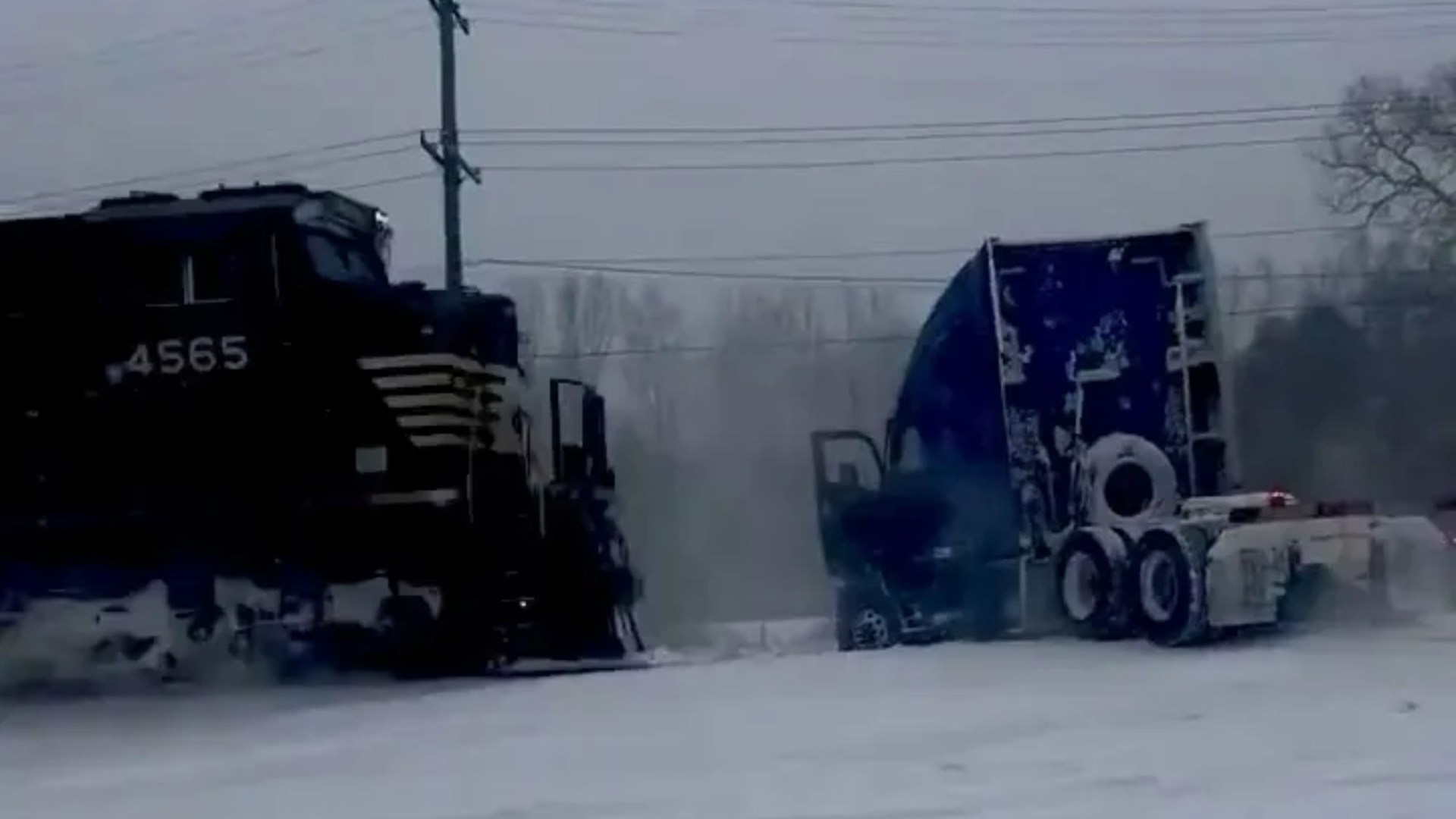 Heart-stopping moment train smashes into a truck stuck on the rail line after a 'bomb cyclone' snowstorm
