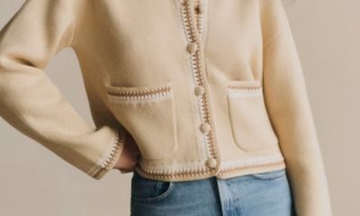 professional young woman wears a deep burgundy short-sleeve knit top with a crew neckline and ribbed hem