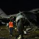 People at the scene where a plane crashed in El Alto, Bolivia. Pic: AP Photo/Juan Karita