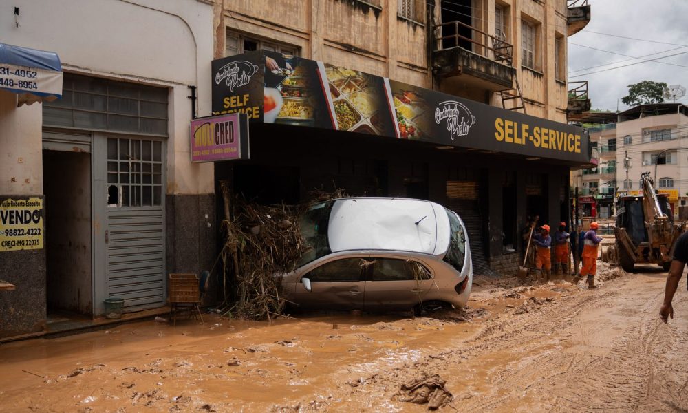 A car is stuck in a snack store after heavy rainfall in south-eastern Brazil. Pic: dpa/AP
