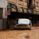 A car is stuck in a snack store after heavy rainfall in south-eastern Brazil. Pic: dpa/AP