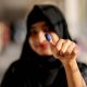 A woman shows her thumb with an ink mark after casting her vote in Dhaka, Bangladesh. Pic: Reuters