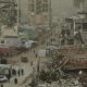 Palestinians walk along a street surrounded by buildings destroyed in recent Israeli air and ground operations. Pic: AP