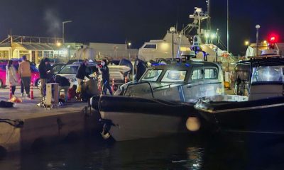 Coast guard officers carry out rescue operations after the collision off the coast of Chios. Pic: AP/Pantelis Fykaris