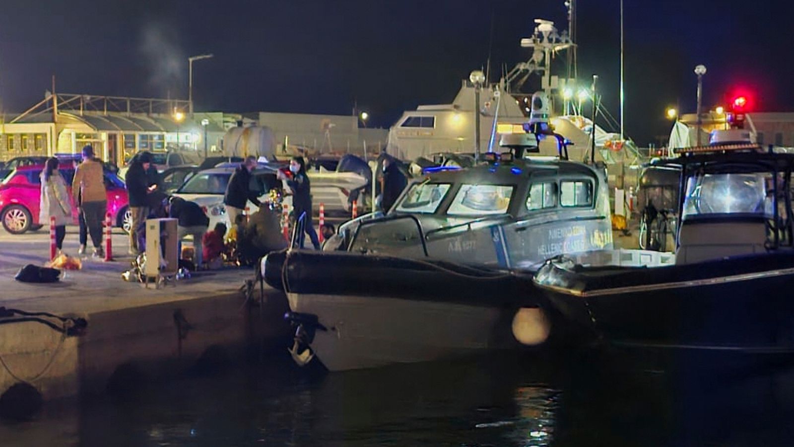 Coast guard officers carry out rescue operations after the collision off the coast of Chios. Pic: AP/Pantelis Fykaris