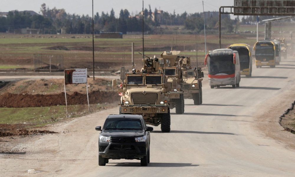 US military vehicles and buses transporting IS detainees from Syria to Iraq. Pic: Reuters