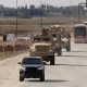 US military vehicles and buses transporting IS detainees from Syria to Iraq. Pic: Reuters