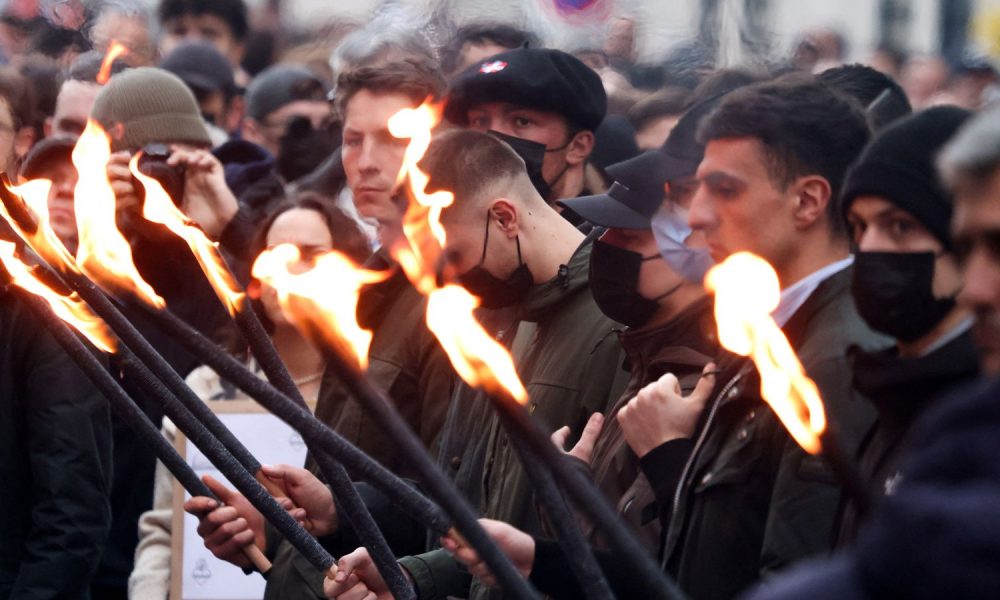 People holding lit torches during the march. Pic: Reuters