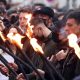 People holding lit torches during the march. Pic: Reuters