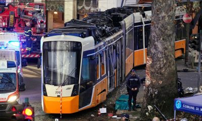 Emergency services work at the scene following a deadly tram derailment in Milan. Pic: AP