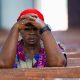 A woman prays at church in Minna, Nigeria, after a separate incident last year which saw scores of people kidnapped. The country has been rocked by sectarian violence in recent years. Pic: Reuters