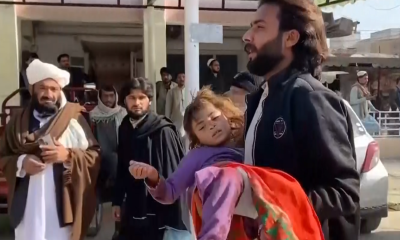 Injured people after a blast near a police station in northwestern Pakistan. Pic: AP