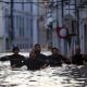 Volunteers wade through a flooded street in Alcacer do Sal. Pic: Reuters