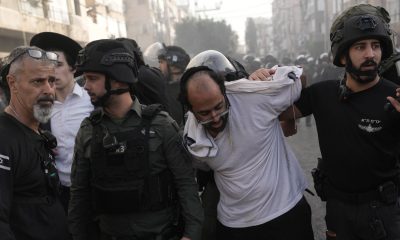 Israeli police detain a man during the protest. Pic: AP