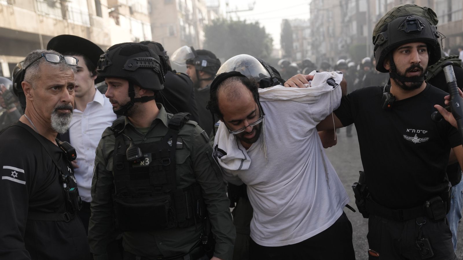Israeli police detain a man during the protest. Pic: AP