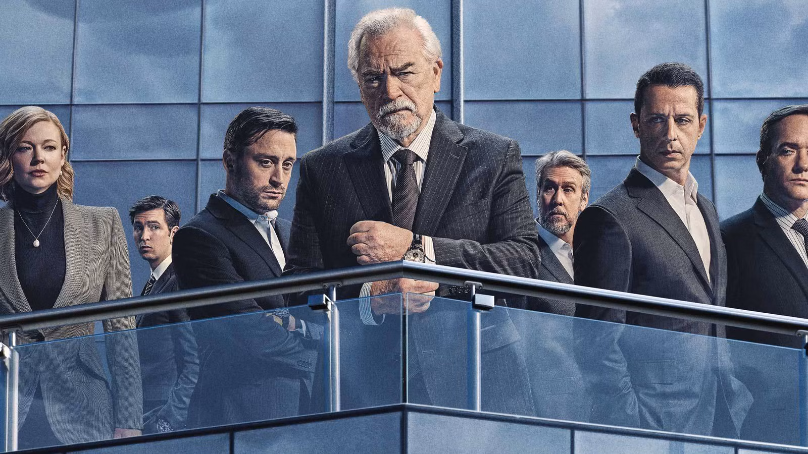 The cast stand on the balcony of a high-rise building in a poster for Succession season 4.