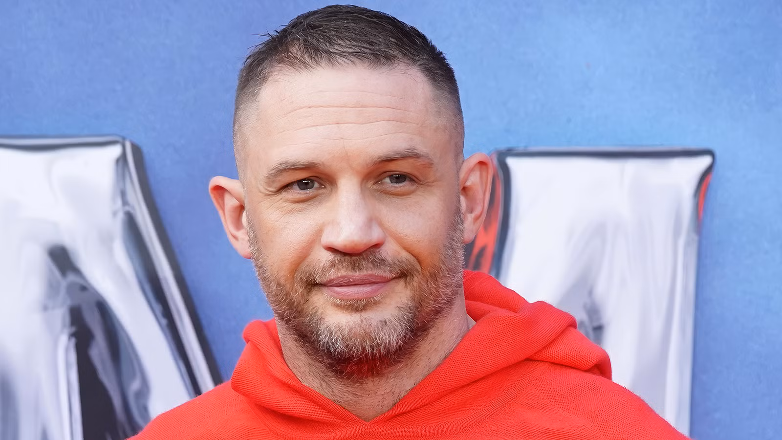Tom Hardy smiling on the red carpet 