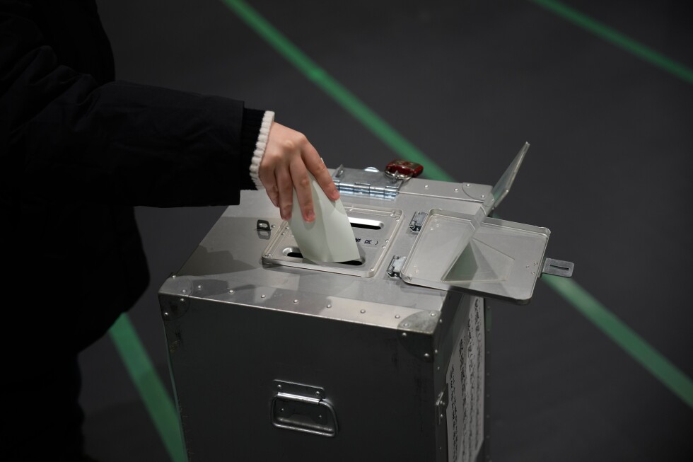 Hawkish Japanese prime minister hopes for big win as polls open