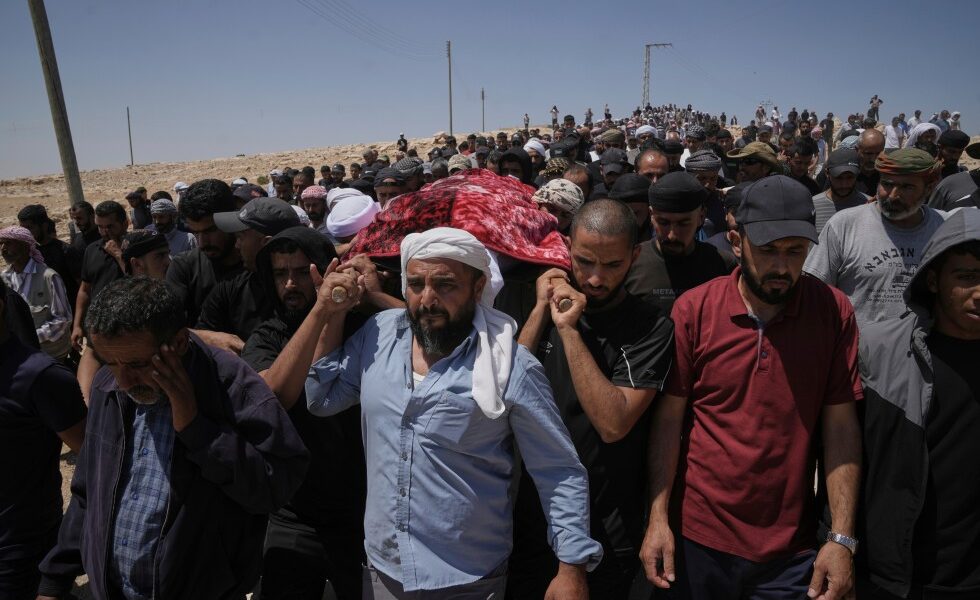 Israel plans to charge a man filmed firing a gun during an attack on a Palestinian activist