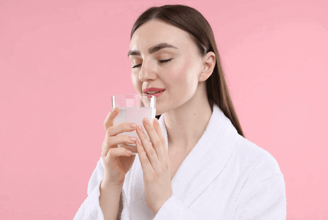 woman drinking hydrolized collagen powder