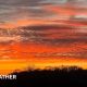A red and yellow sunset lights up the rural landscape across south-east England.