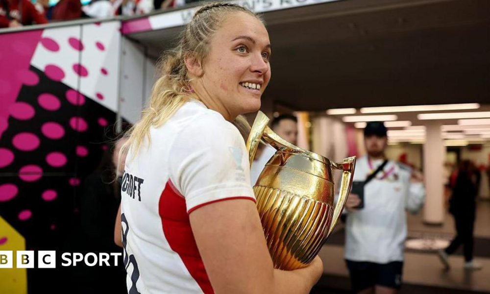 Zoe Stratford carrying the Women's Rugby World Cup trophy