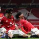 JJ Gabriel (centre) celebrates Junior Brown's (right) match winner with Jay McEvoy for Manchester United in the FA Youth Cup at Old Trafford
