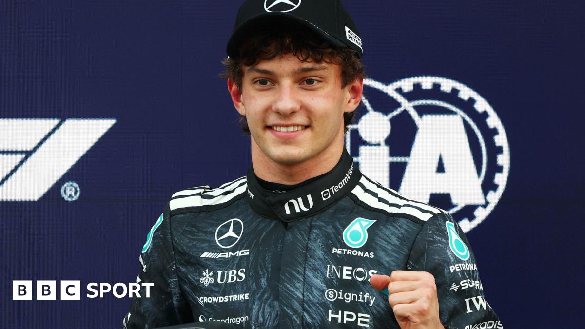 Kimi Antonelli is presented with his pole position award by Japanese sumo wrestler Kotozakura Masakatsu II
