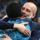 Pep Guardiola hugs his players