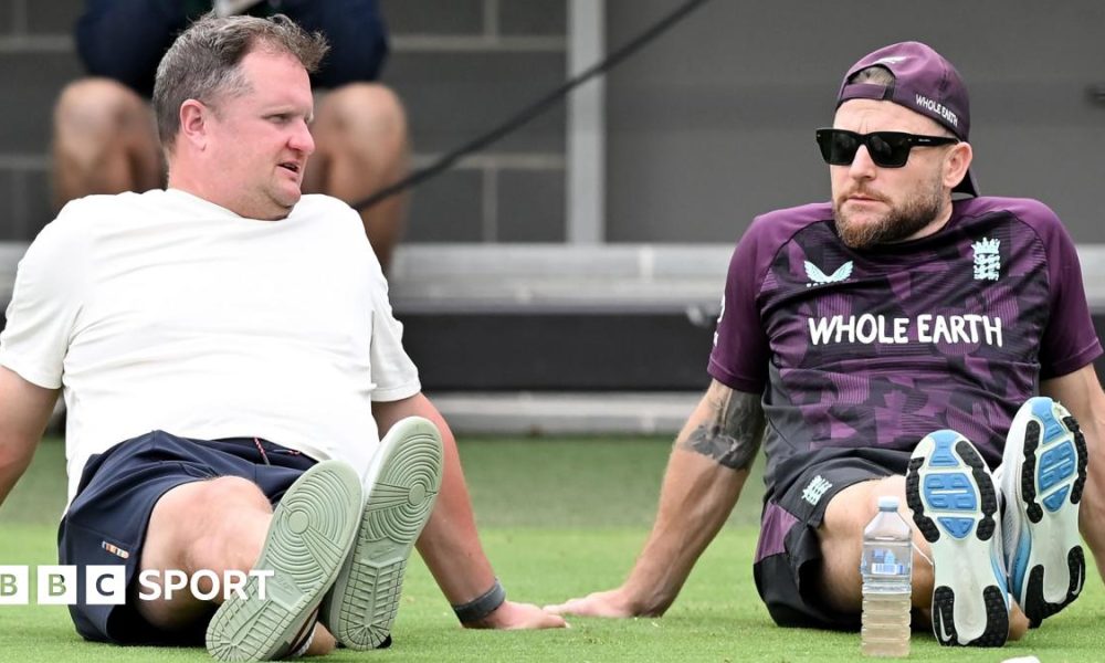 Rob Key and Brendon McCullum sitting on the grass at Lilac Hill during an England pre-Ashes warm-up match