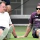 Rob Key and Brendon McCullum sitting on the grass at Lilac Hill during an England pre-Ashes warm-up match