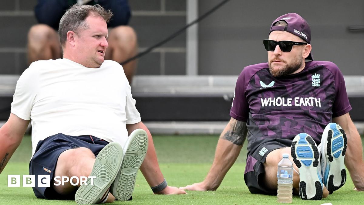Rob Key and Brendon McCullum sitting on the grass at Lilac Hill during an England pre-Ashes warm-up match