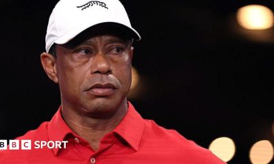 Tiger Woods in a red shirt and white cap