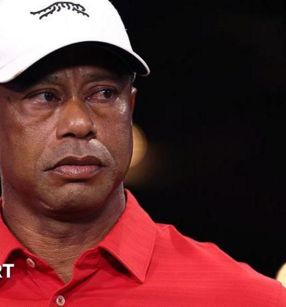 Tiger Woods in a red shirt and white cap