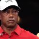 Tiger Woods in a red shirt and white cap