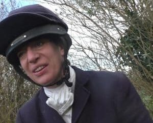 A female member of the hunt smirks at the hunt sabs