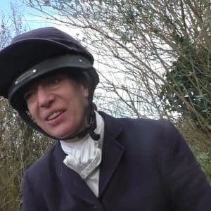 A female member of the hunt smirks at the hunt sabs