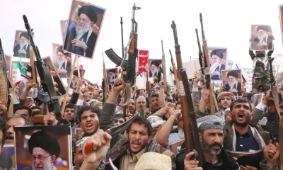 Houthi supporters raise posters of the late Iranian Supreme Leader Ayatollah Ali Khamenei as they chant slogans against Israel and the United States during a rally in Sanaa, Yemen, Sunday, March 1, 2026.